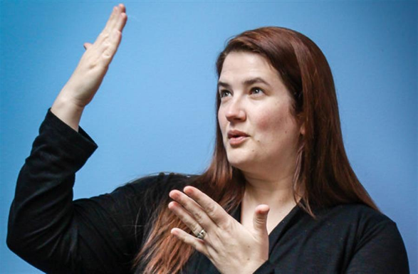 A woman interpreting.